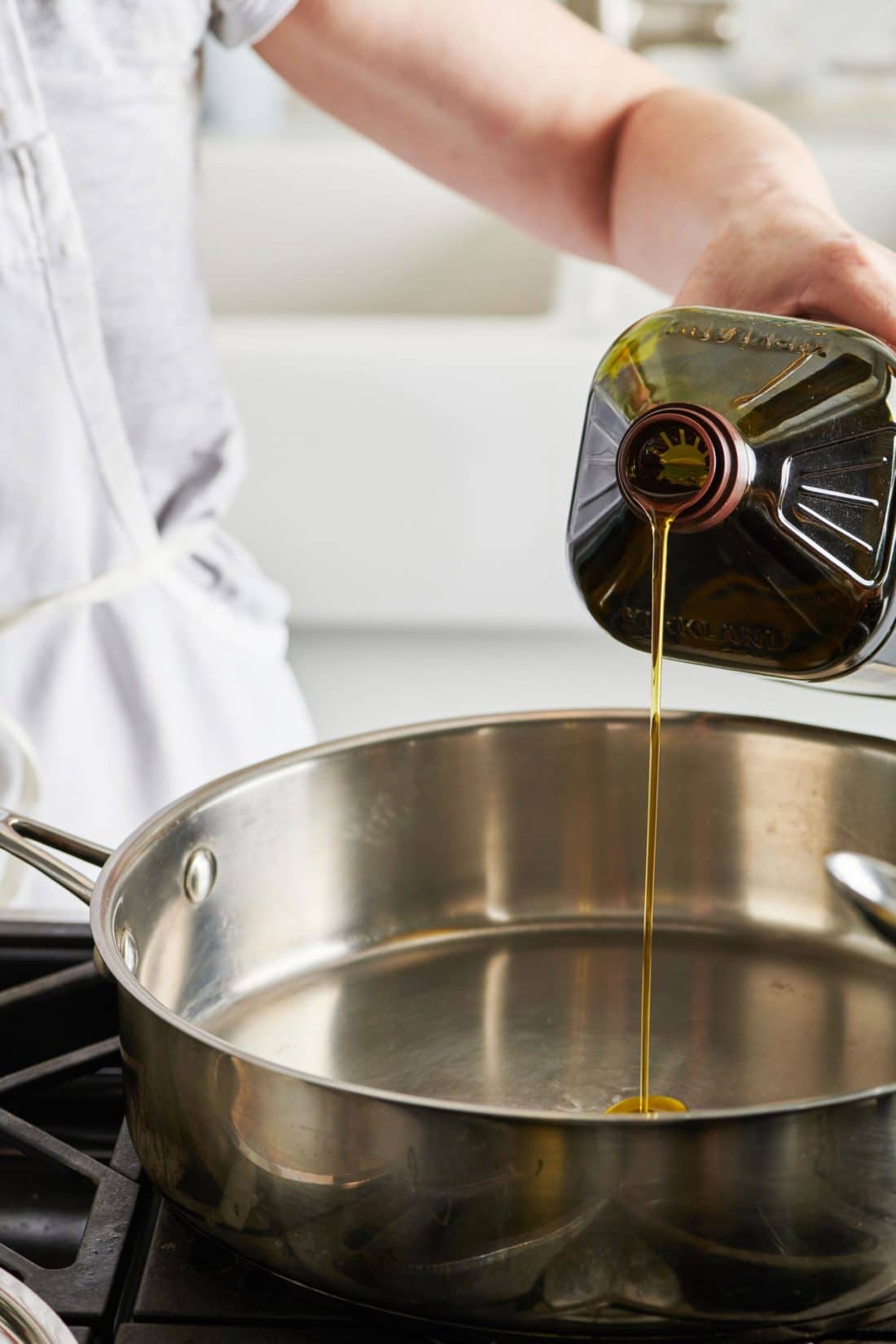 Olive oil pouring into a pan.