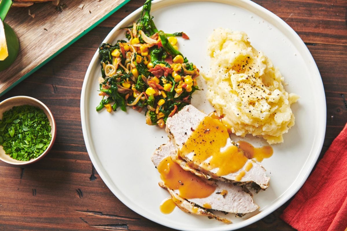 Plate with vegetables, mashed potatoes, and slices of Turkey Breast with gravy.