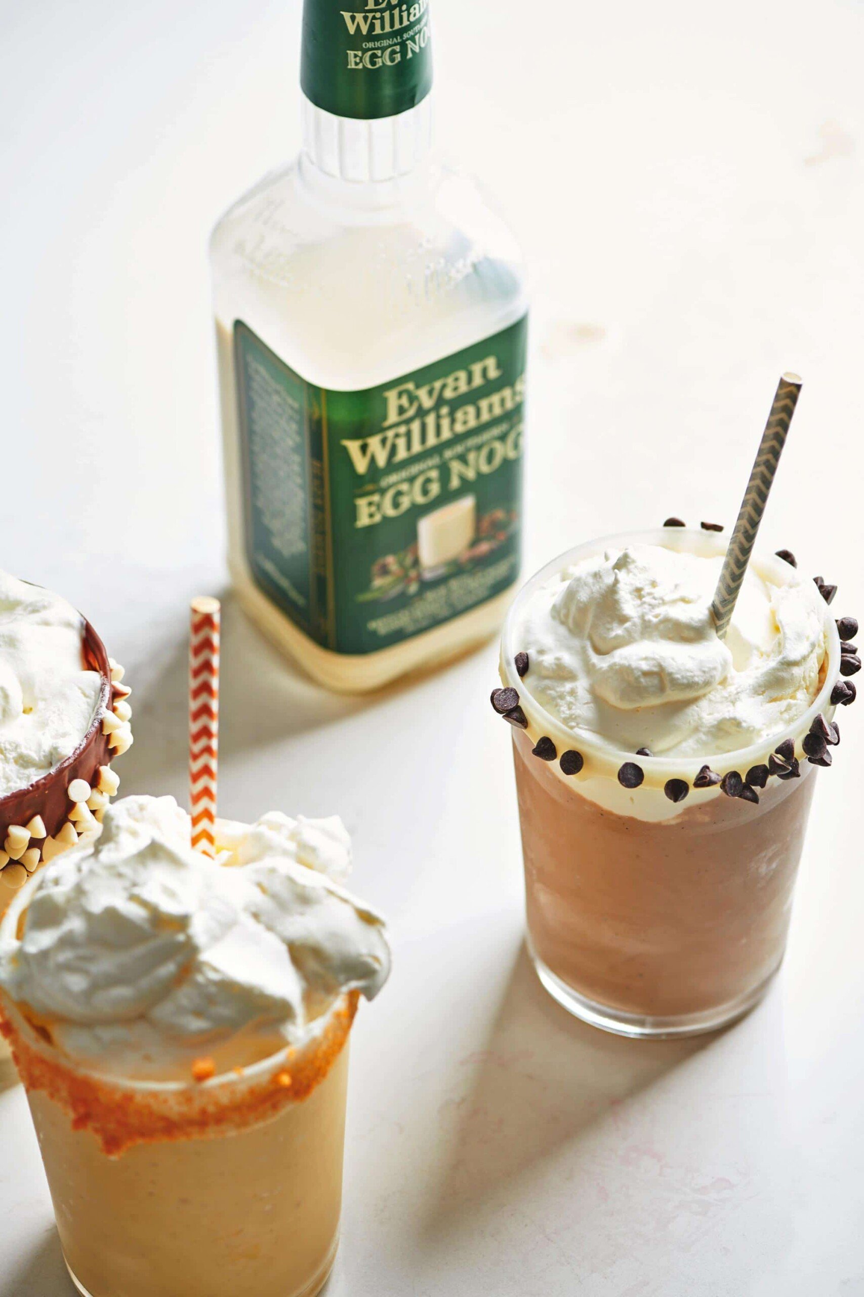Bottle of Evan Williams Egg Nog with glasses of milkshakes.
