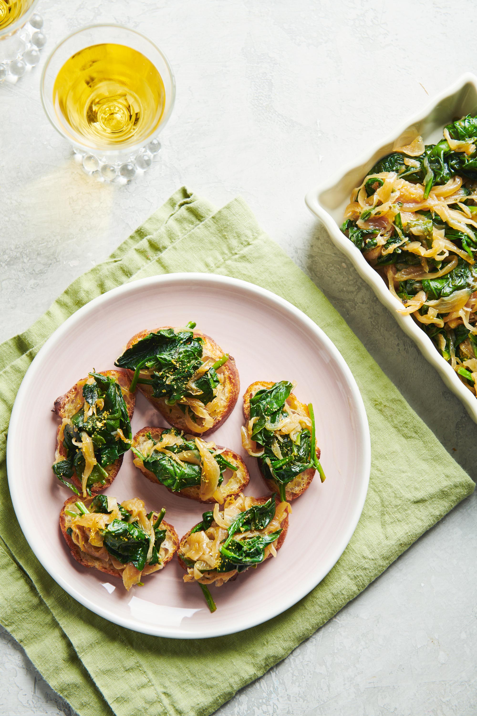 Caramelized Onion and Spinach Crostini on a plate.