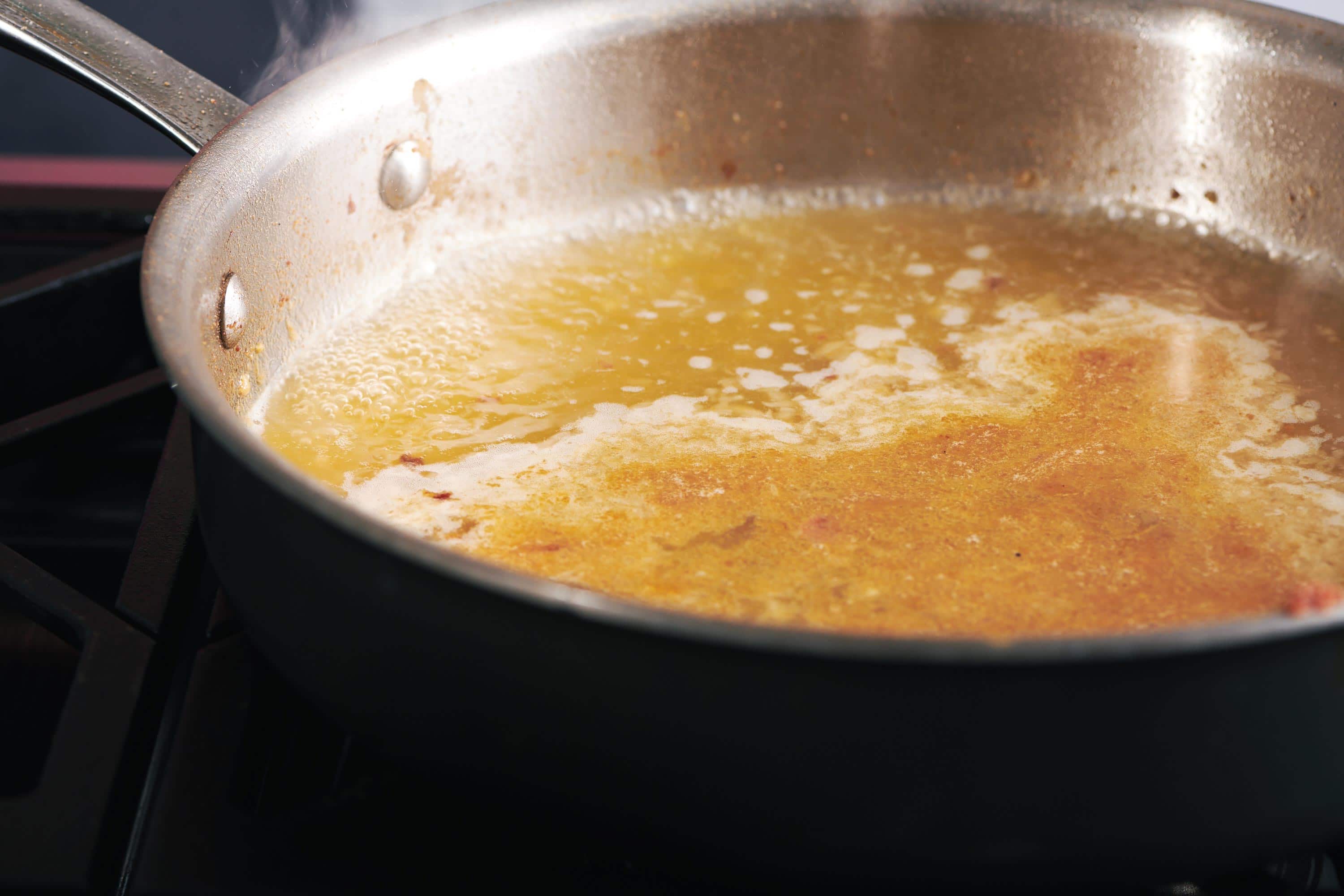 Broth simmering in a skillet.