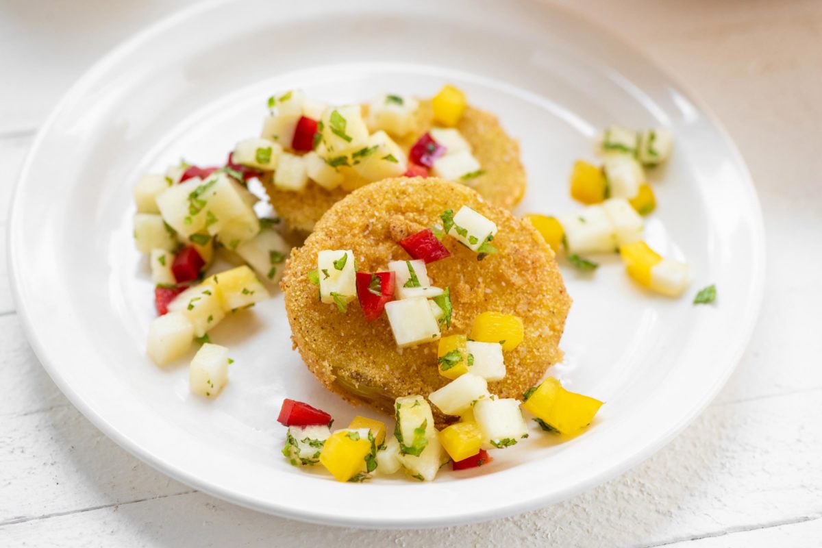 Small white plate of Fried Green Tomatoes with Pineapple Mint Salsa.