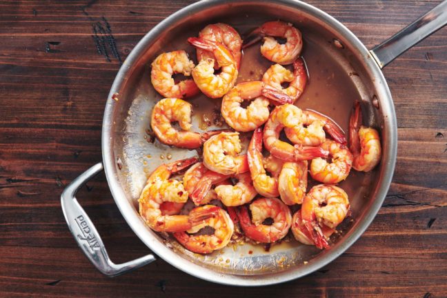 Honey Garlic Shrimp in a pan on a wooden table.