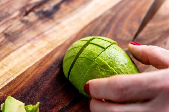 Slicing avocado on a cutting board