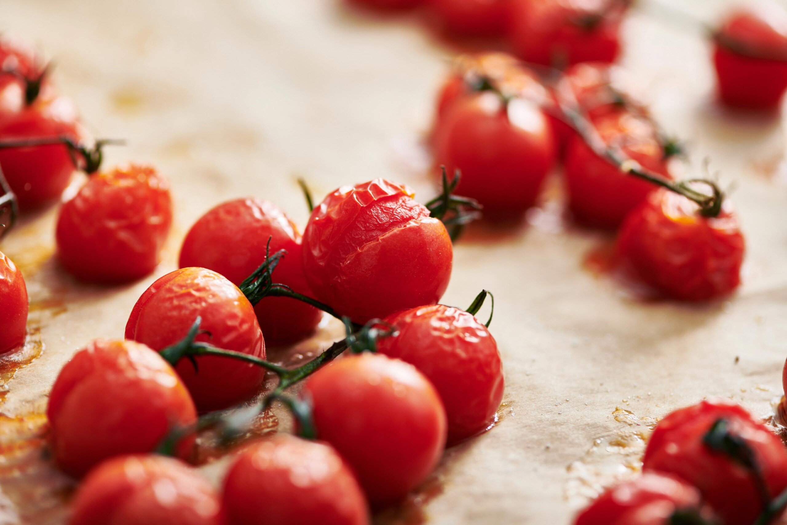 Roasted cherry tomatoes on baking sheet.