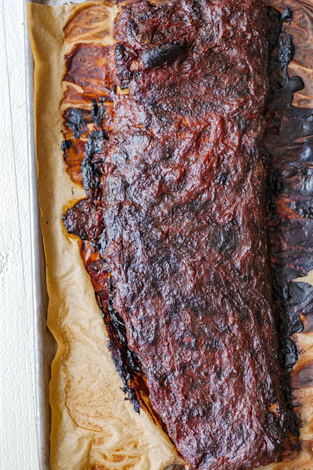 Cajun Sticky Ribs on a lined baking sheet.