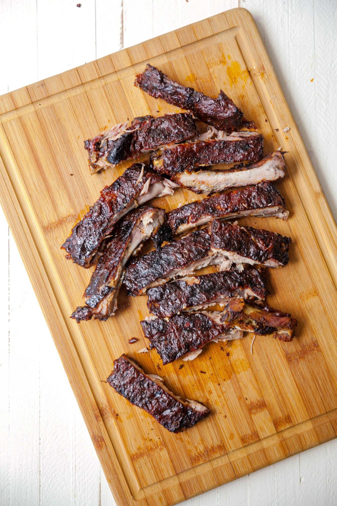 Cajun Sticky Ribs on a wooden cutting board.