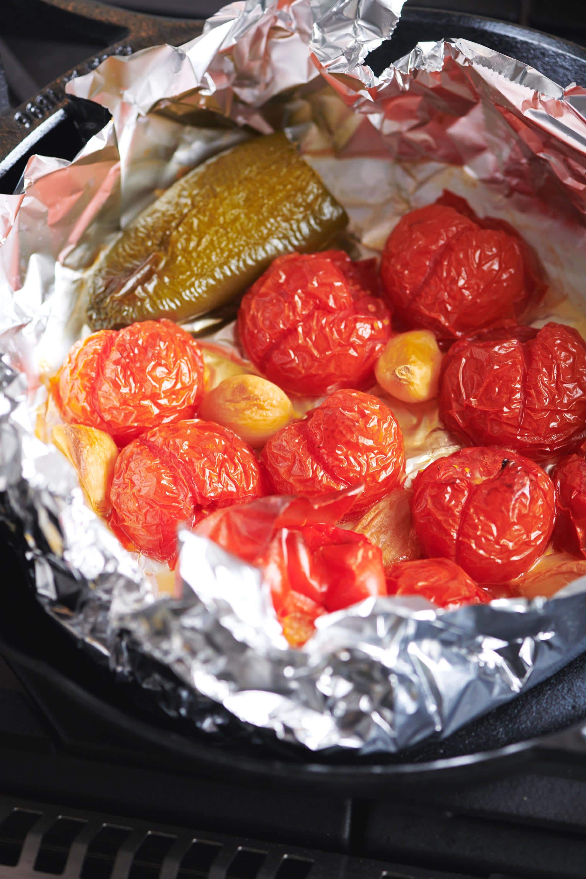 Hot pepper, tomatoes, and garlic in foil.