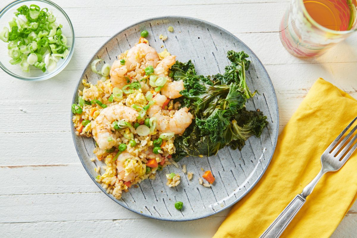 Shrimp Fried Rice on a plate with greens.