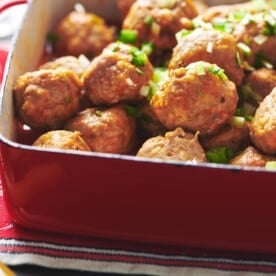 Buffalo Chicken Meatballs piled high in a red baking dish.