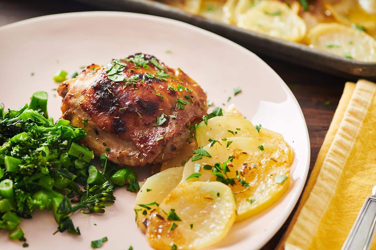 Roasted Marinated Chicken and Potatoes on a white plate.