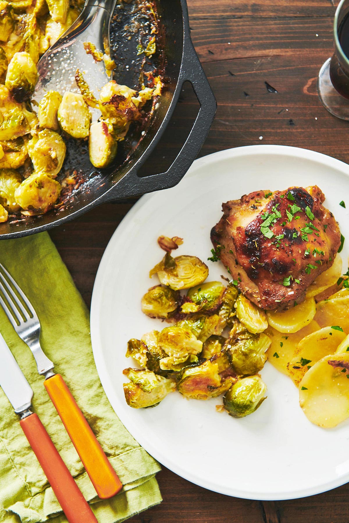 Plate of Roasted Marinated Chicken and Potatoes and brussels sprouts.