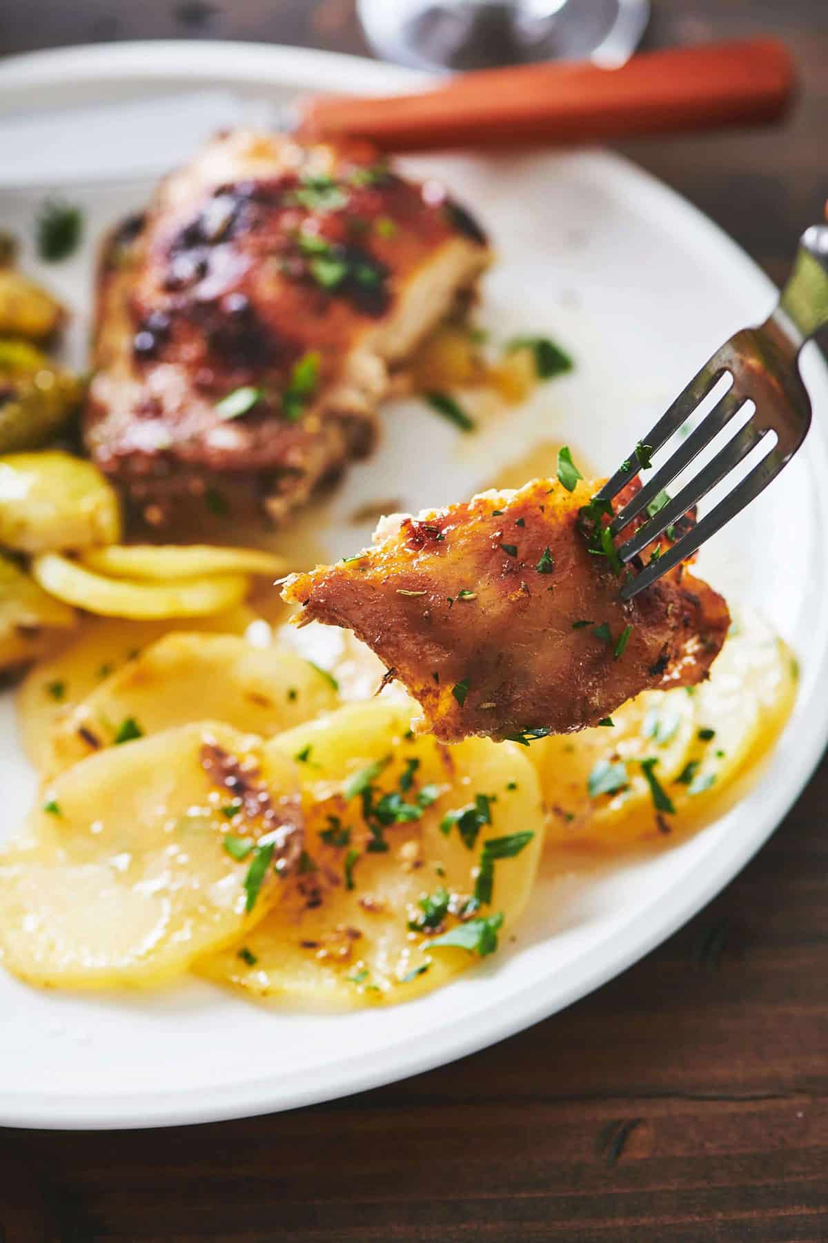 Fork grabbing a piece of Roasted Marinated Chicken.