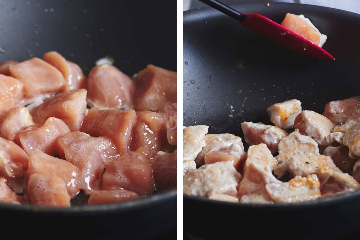 Cooking cubed chicken in black pan.