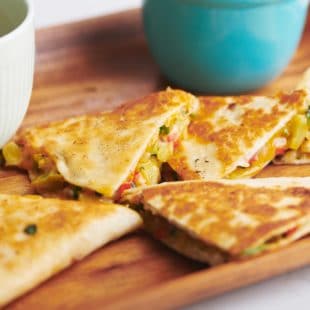 Vegetable Quesadillas on a wooden tray.