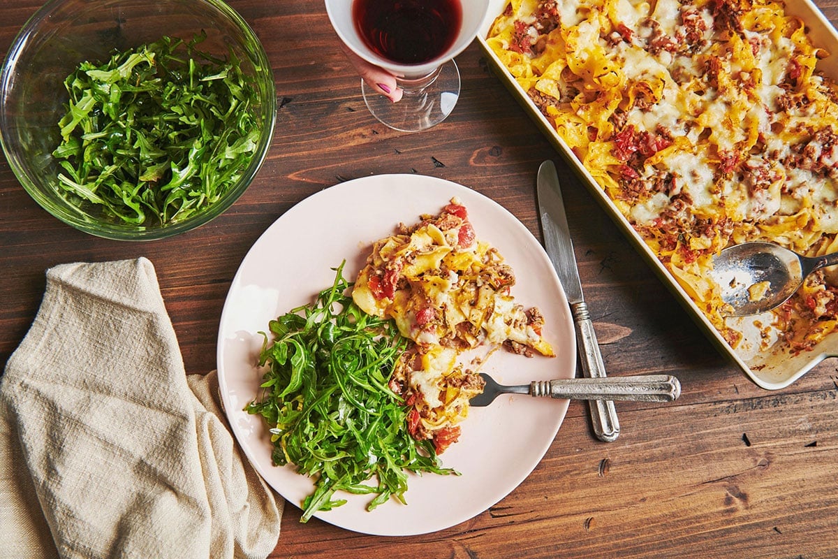 Plate with Beef and Three Cheese Noodle Casserole and salad.