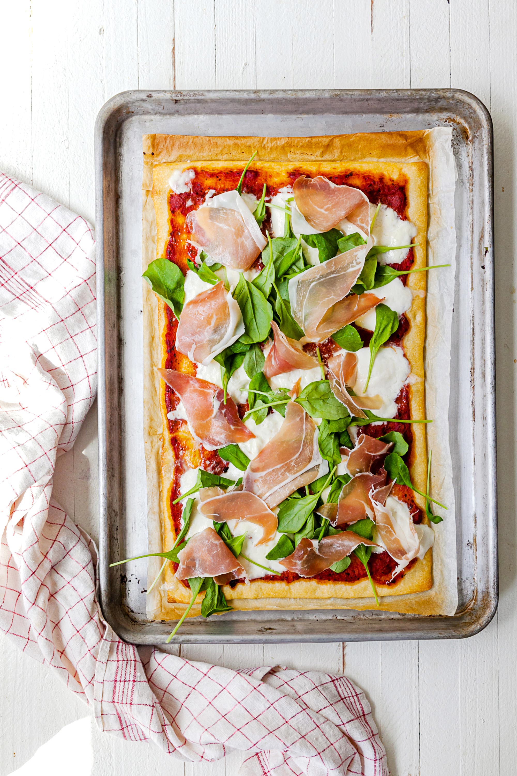 Burrata and Prosciutto Pizza on baking sheet.