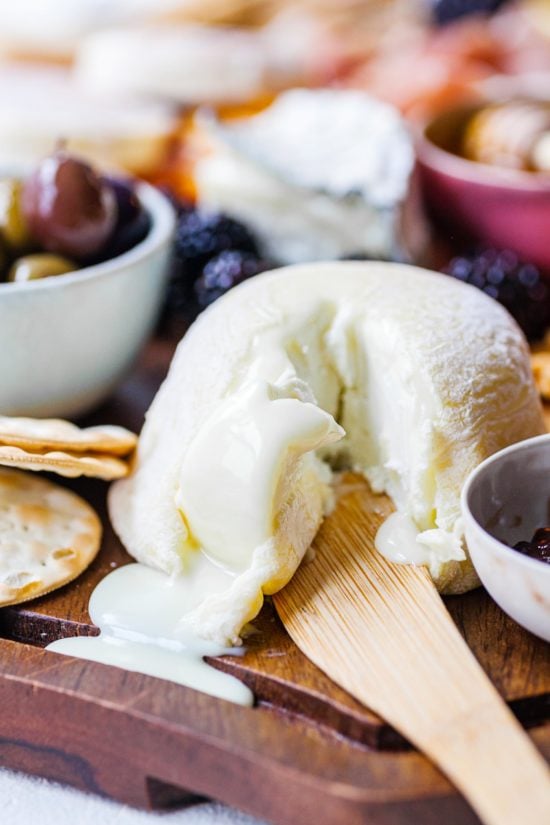 Soft white cheese surrounded by other grazing board foods.