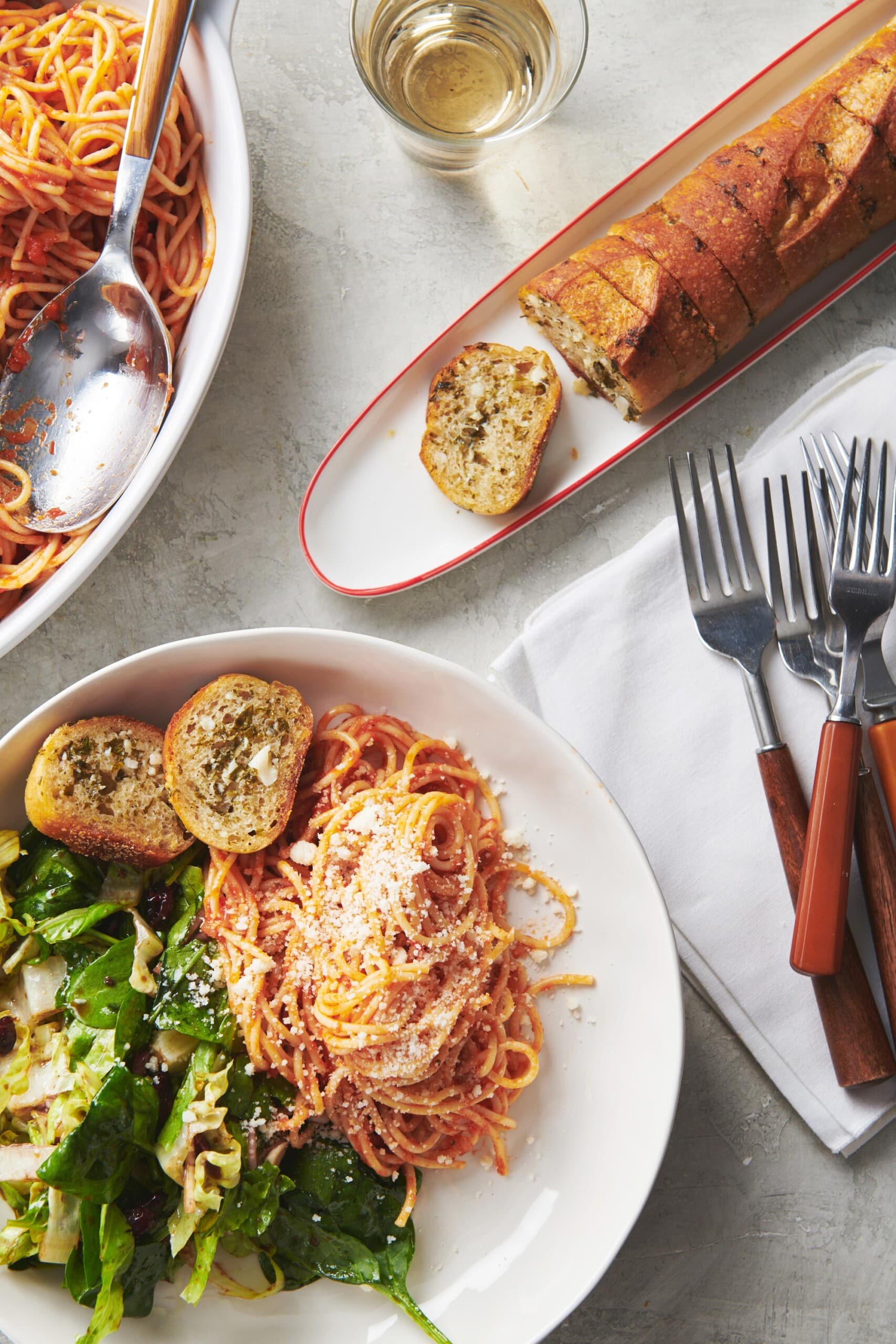 Ranch Garlic Bread on a plate with pasta and salad.