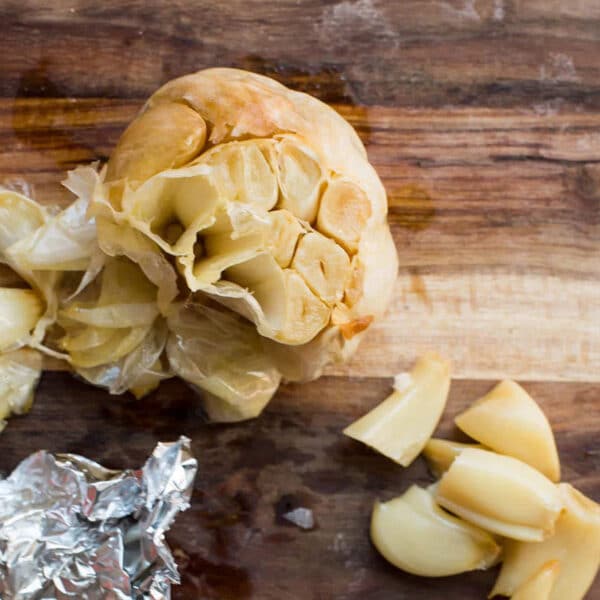 Roasted garlic cloves on cutting board.