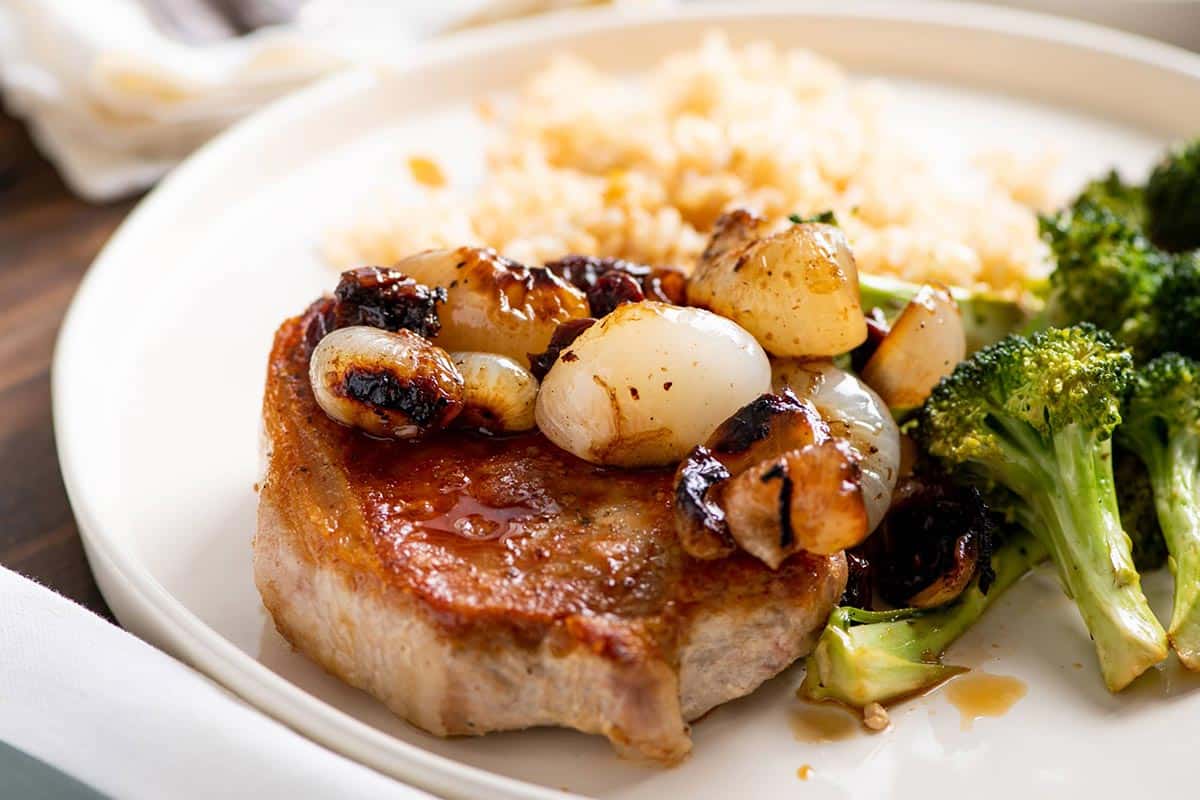 Braised Cipollini Onions with Dried Cherries on pork chop with broccoli and rice on the side.