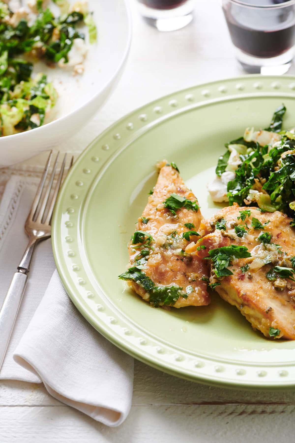 Plate with Chicken Piccata next to a fork.