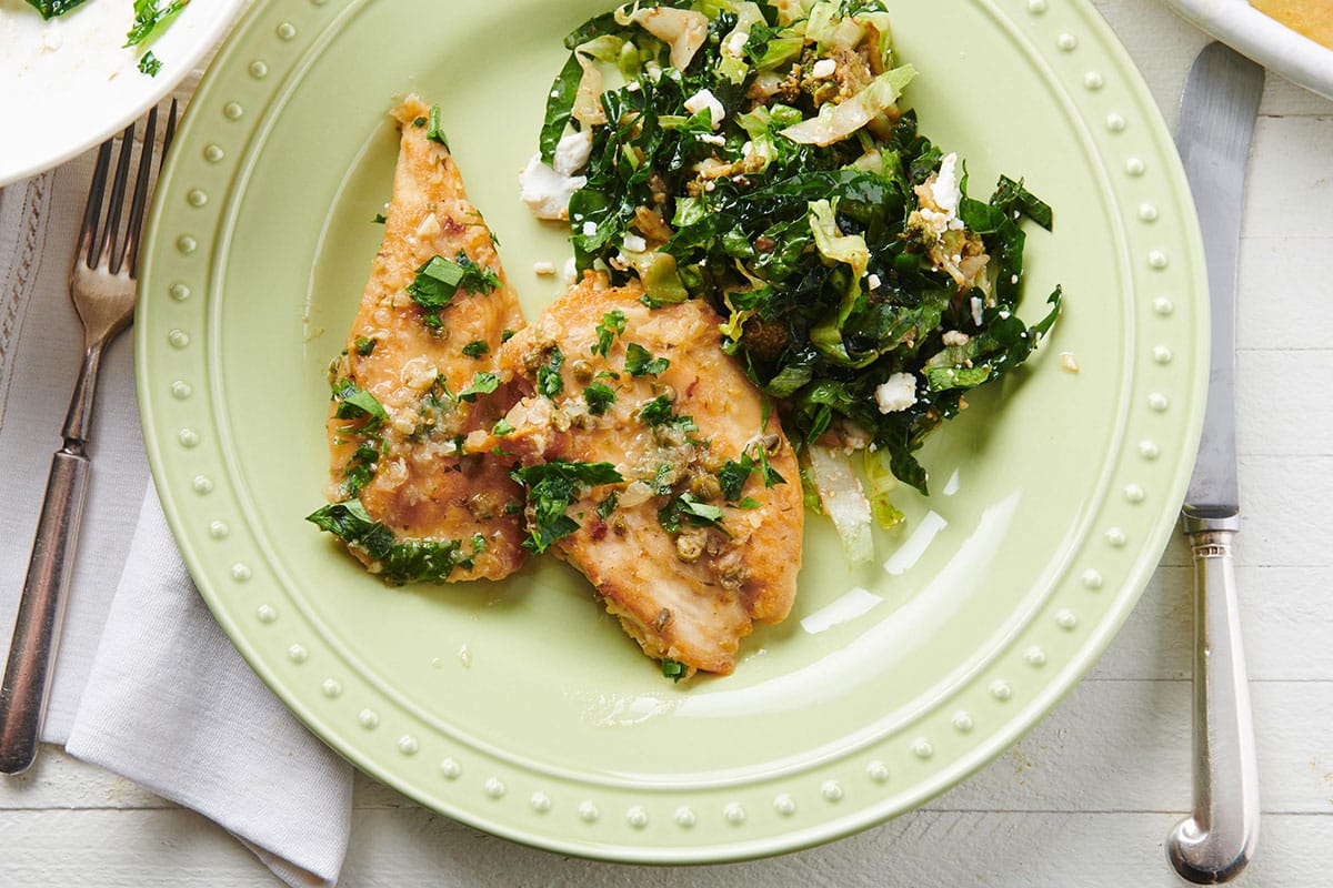 Chicken Piccata on a plate with greens.