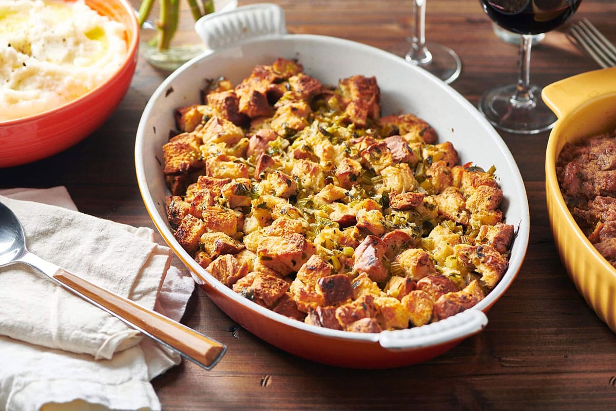Red and white dish filled with traditional Thanksgiving dressing.