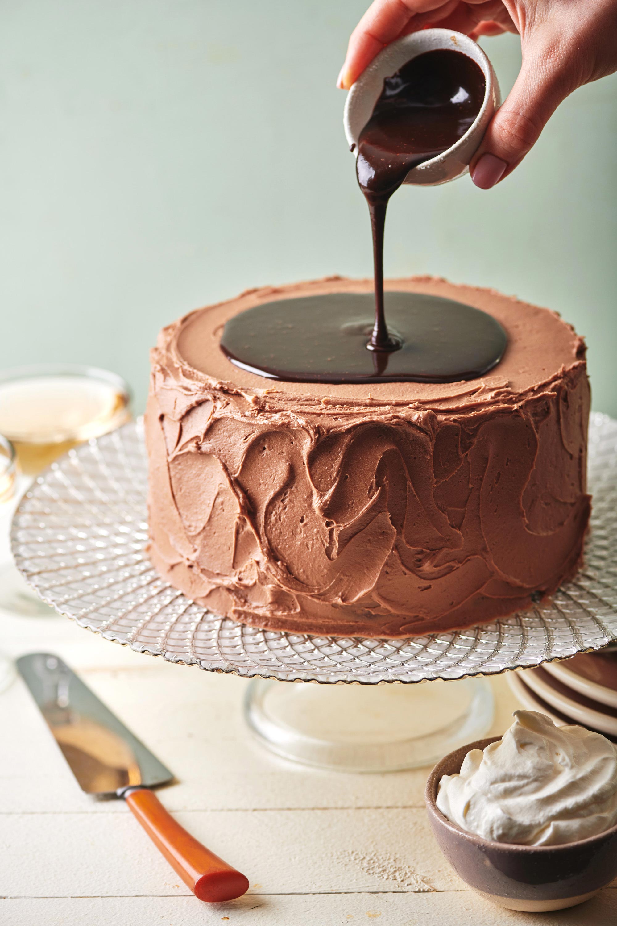Chocolate pouring onto a Devil's Food Cake.