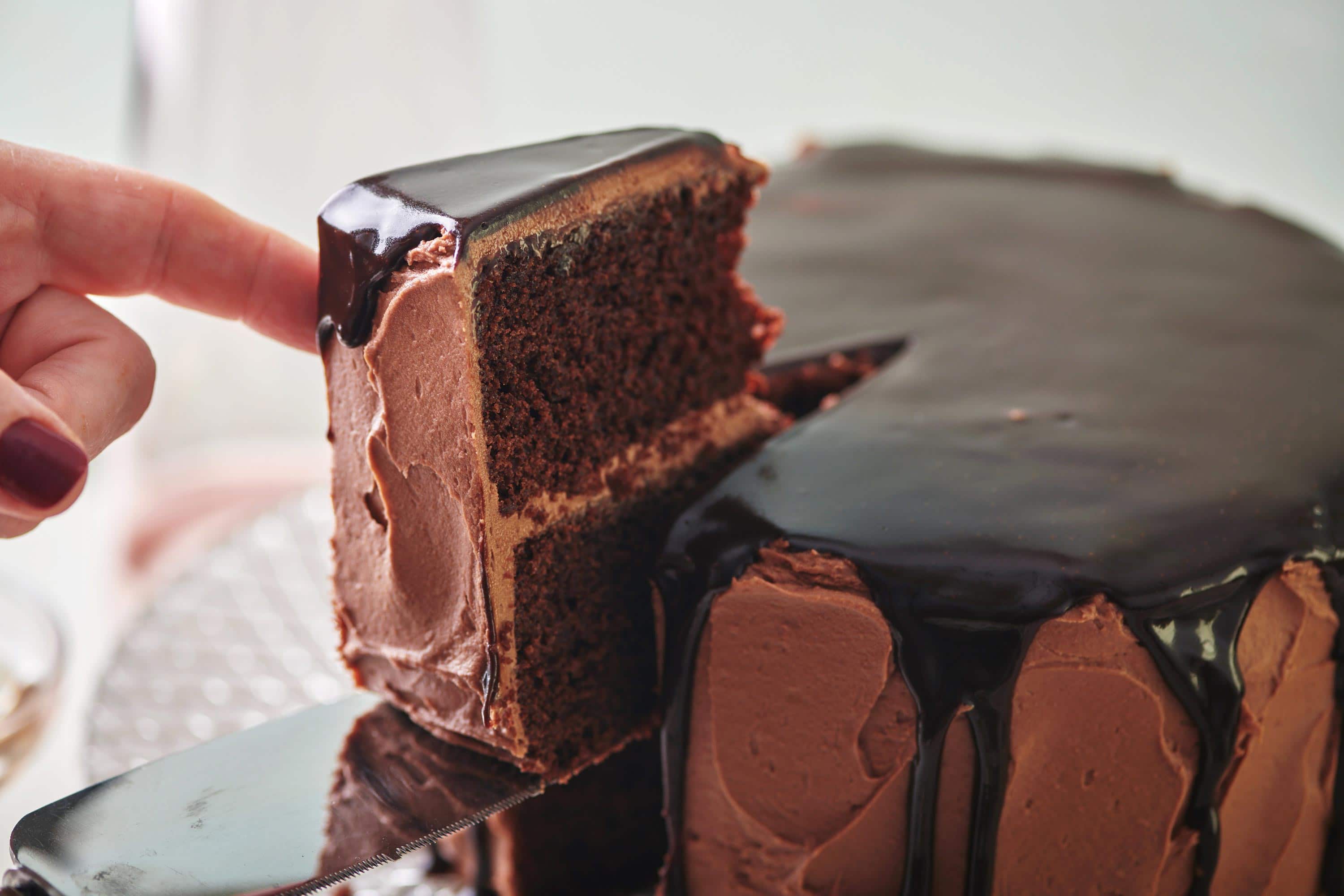 Slice being removed from a Devil\'s Food Cake.