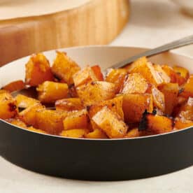 Maple Roasted Butternut Squash in dish on table.