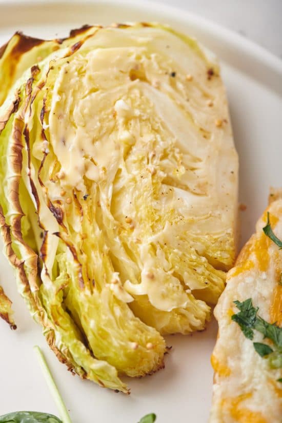 Roasted Cabbage Wedge on a white plate.