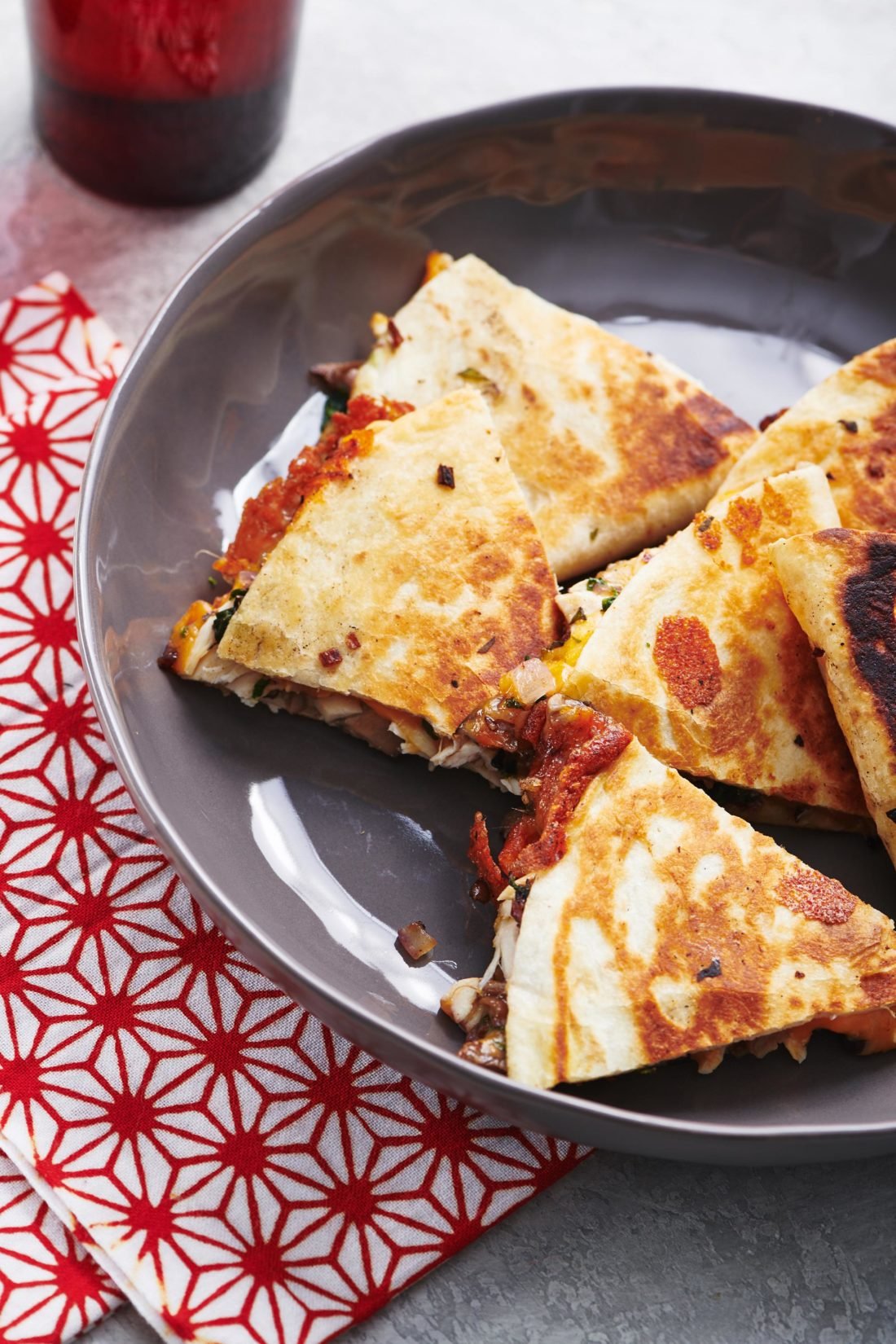 Chicken, Onion and Mushroom Quesadillas piled on a plate.