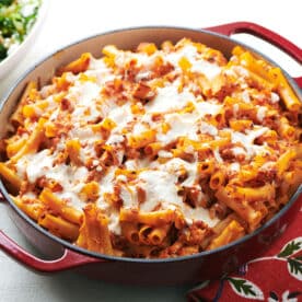 Chicken Parmesan Baked Ziti in red pan on table.
