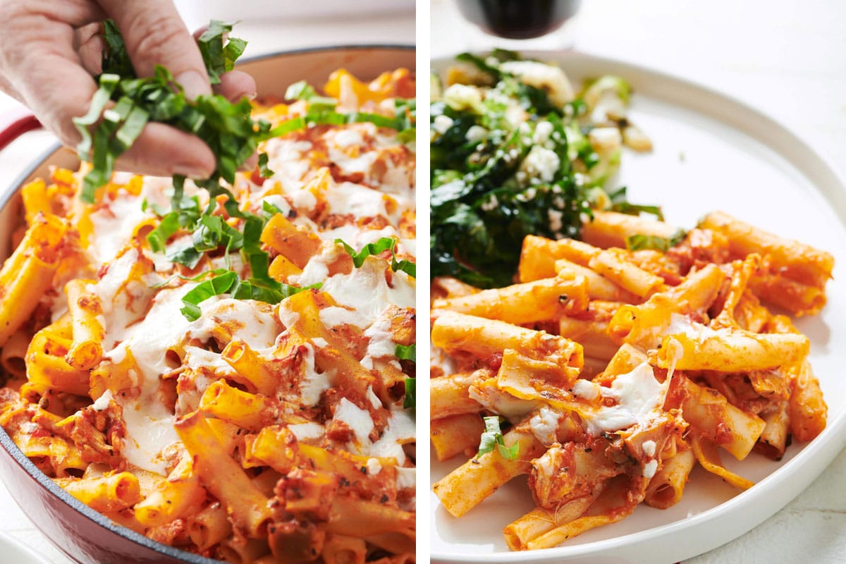 Topping chicken Parmesan baked ziti with basil and serving with salad on plate.
