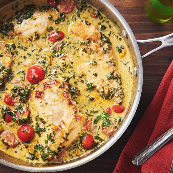 Creamy Tuscan Chicken in skillet on table.