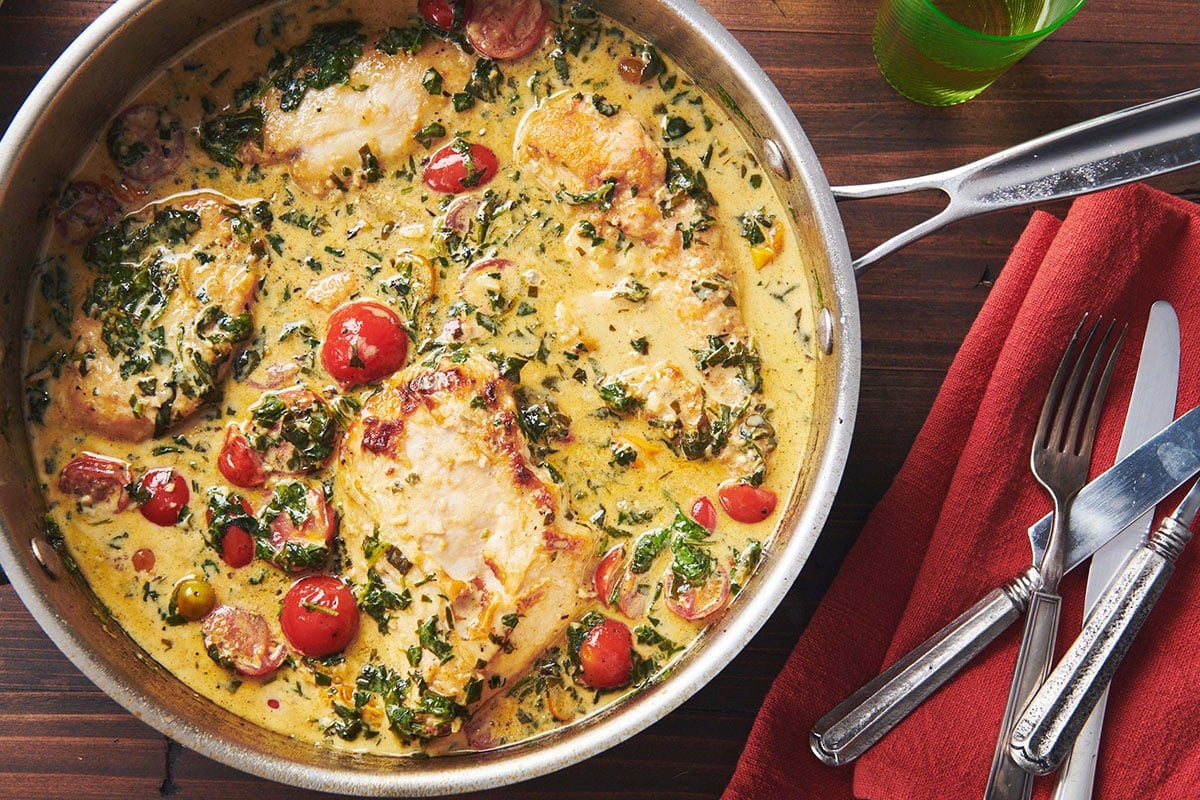 Creamy Tuscan Chicken in skillet on table.