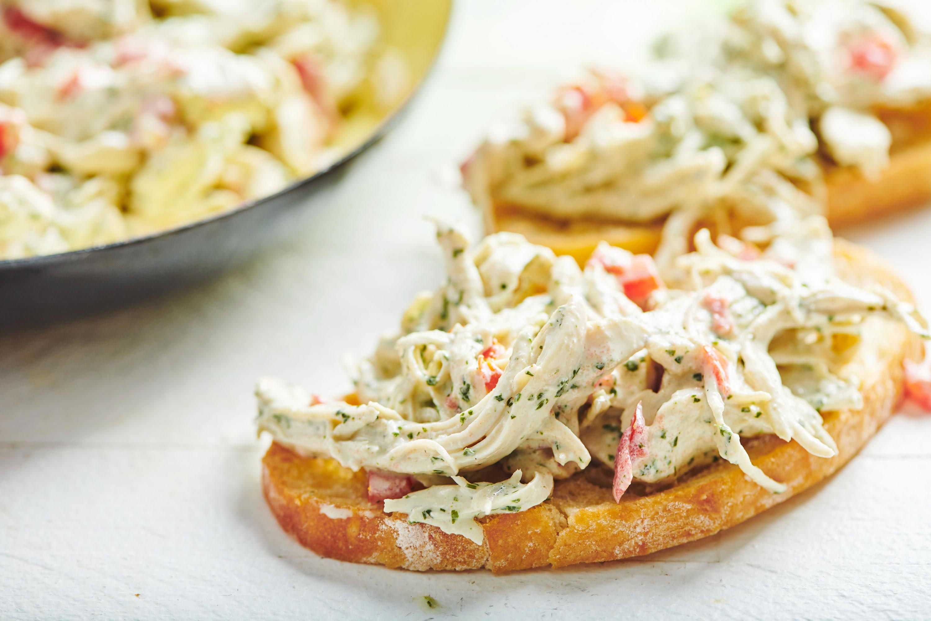 Toasted baguette bread topped with shredded chicken salad.