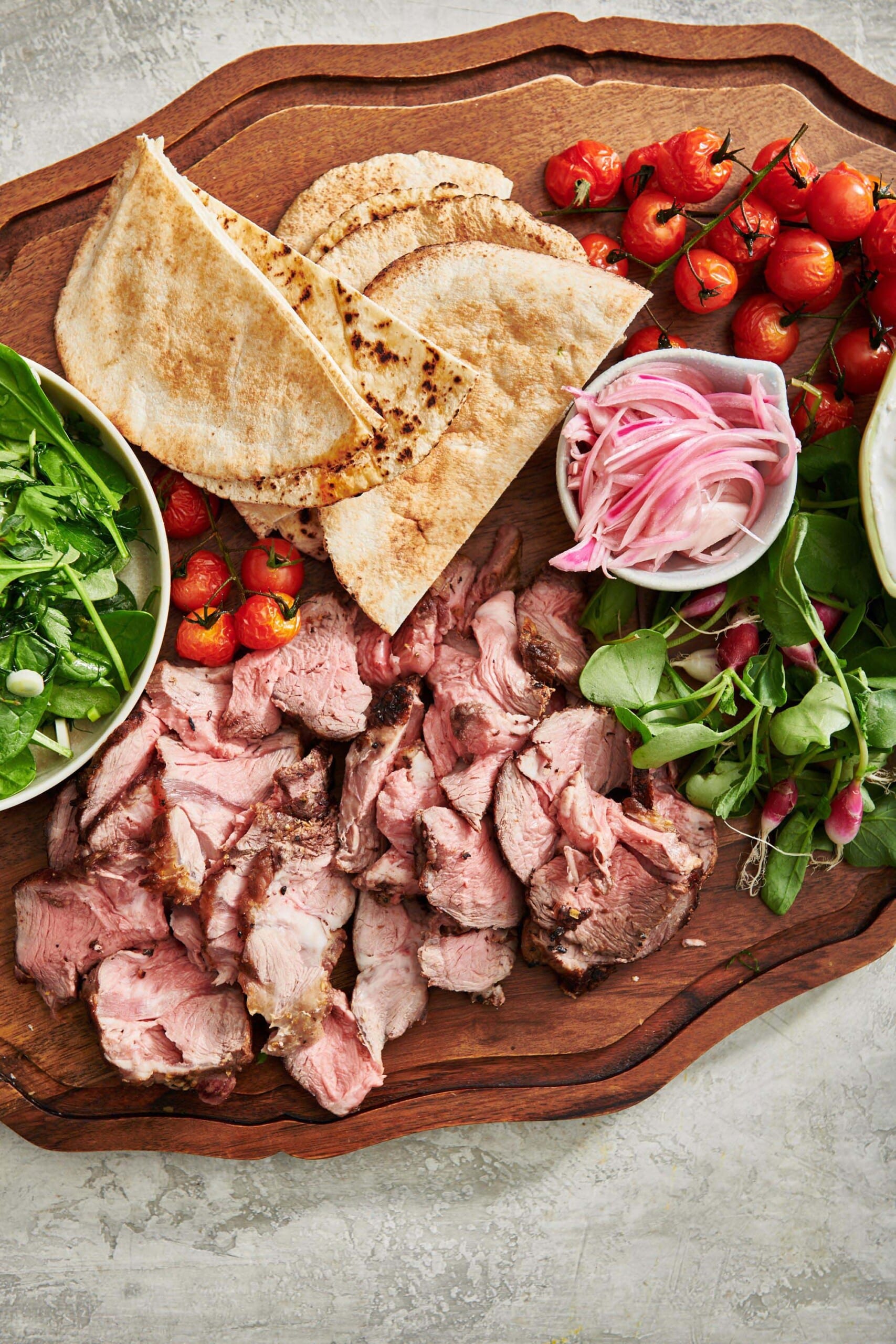 Lamb Gyro ingredients on a wooden board.