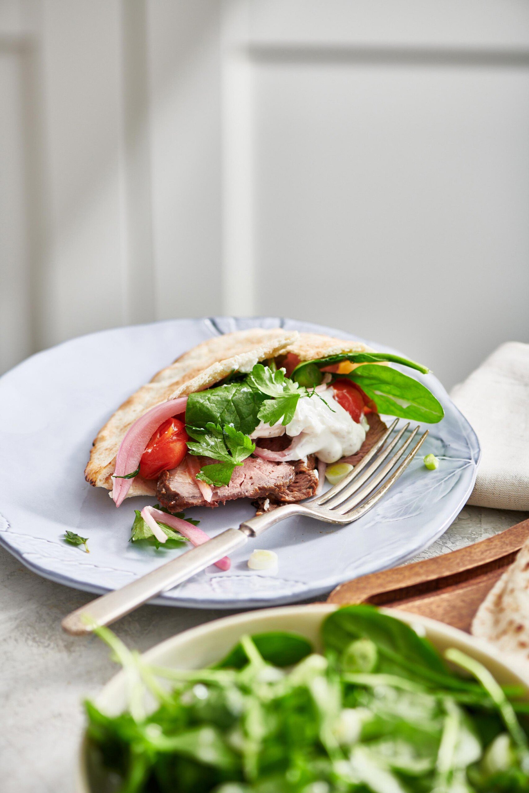 Lamb Gyro on a plate with a fork.