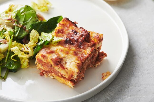 Slice of Classic Cheesy Beefy Lasagna on a white plate.