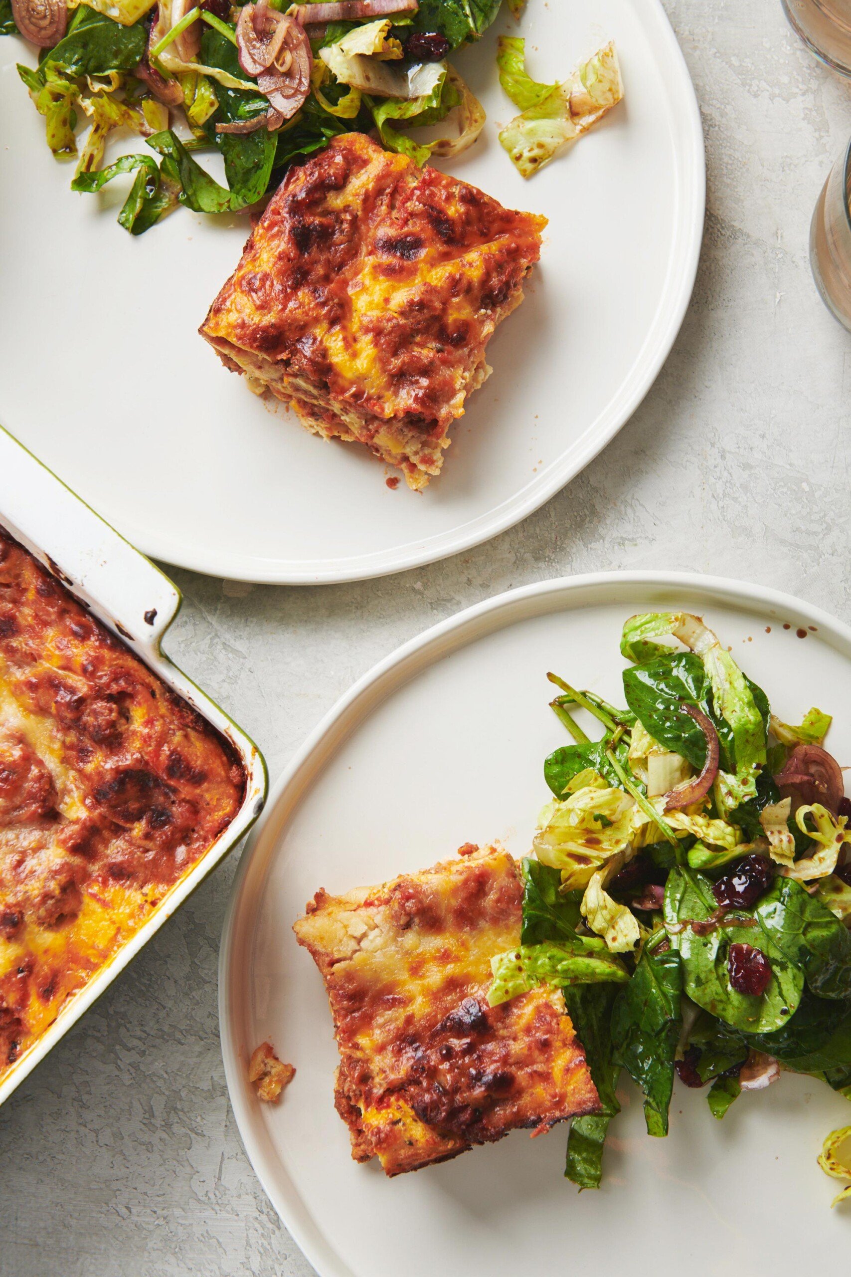 Plates with Lasagna and salad.