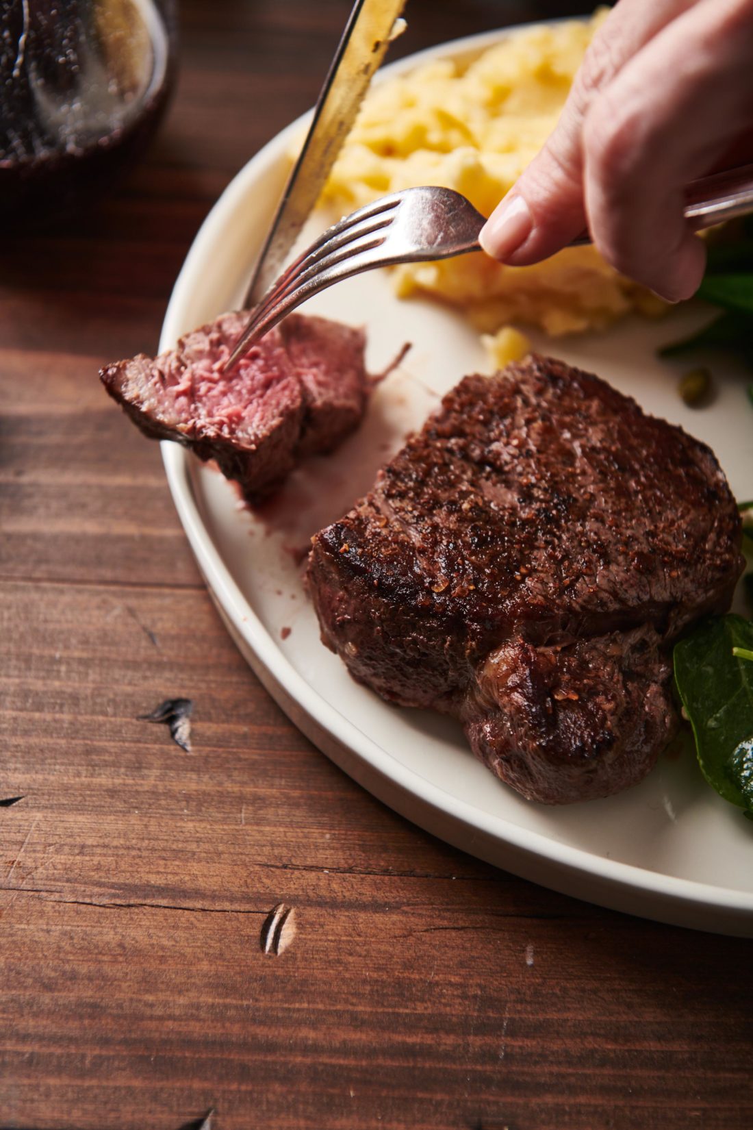 Fork grabbing a piece of Filet Mignon.