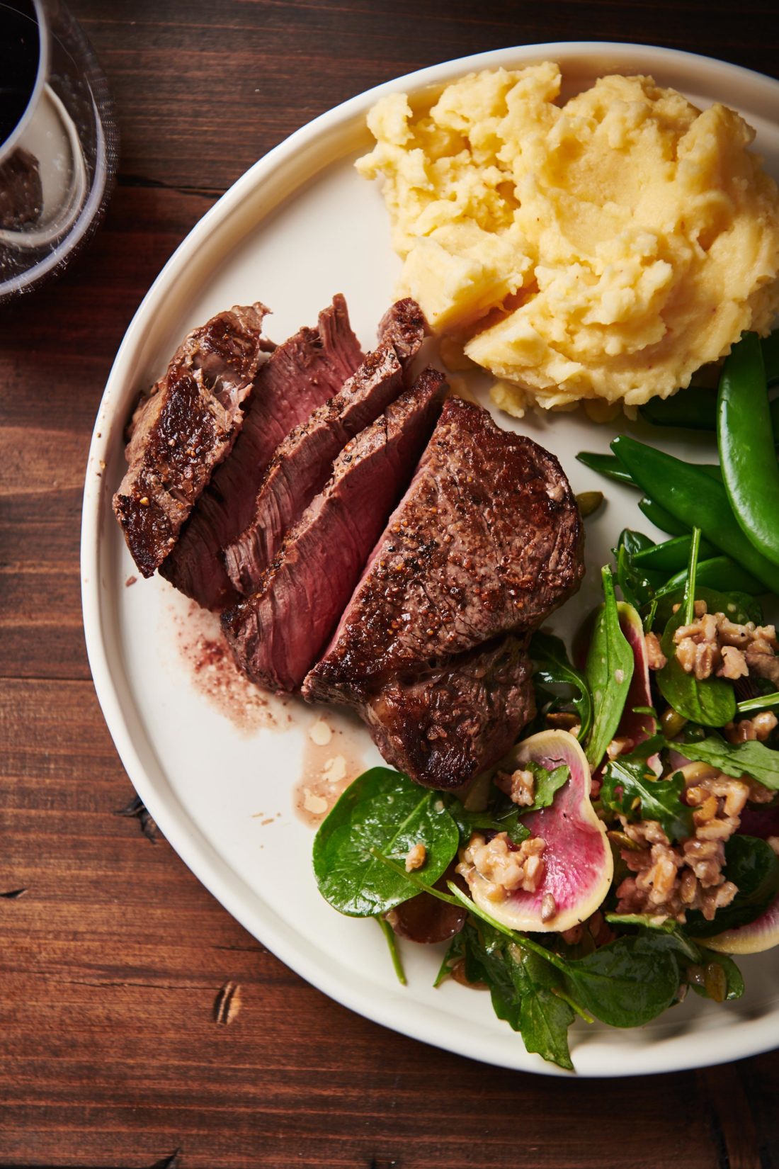 Plate of Filet Mignon, salad, vegetables, and mashed potatoes.