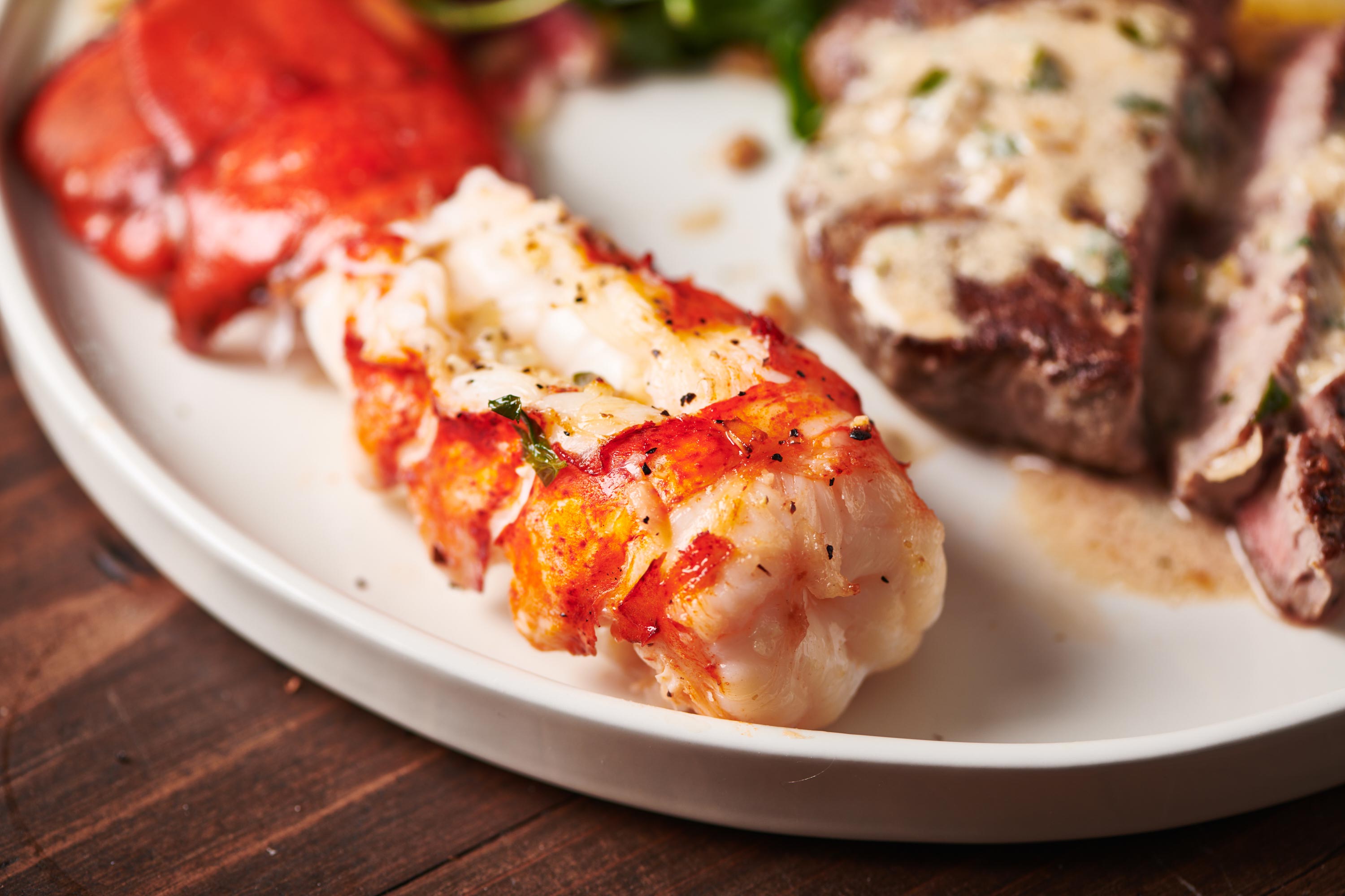Shelled lobster tail on a plate.