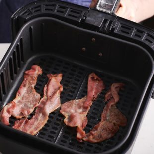 Bacon cooking in an Air Fryer.