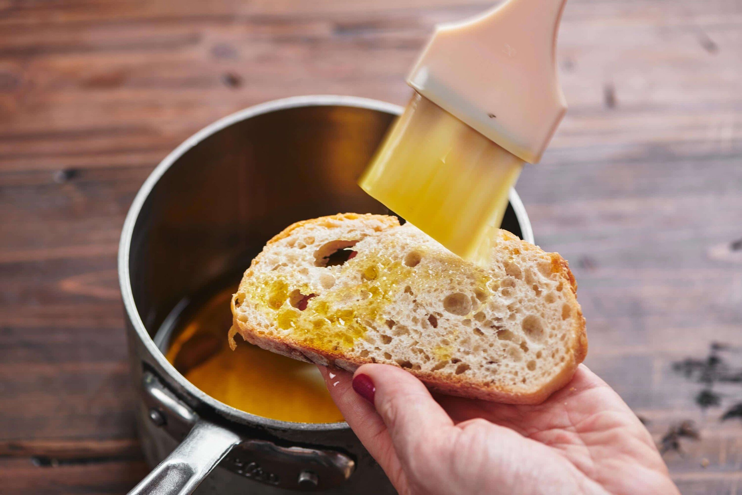 Brushing garlic oil on bread.