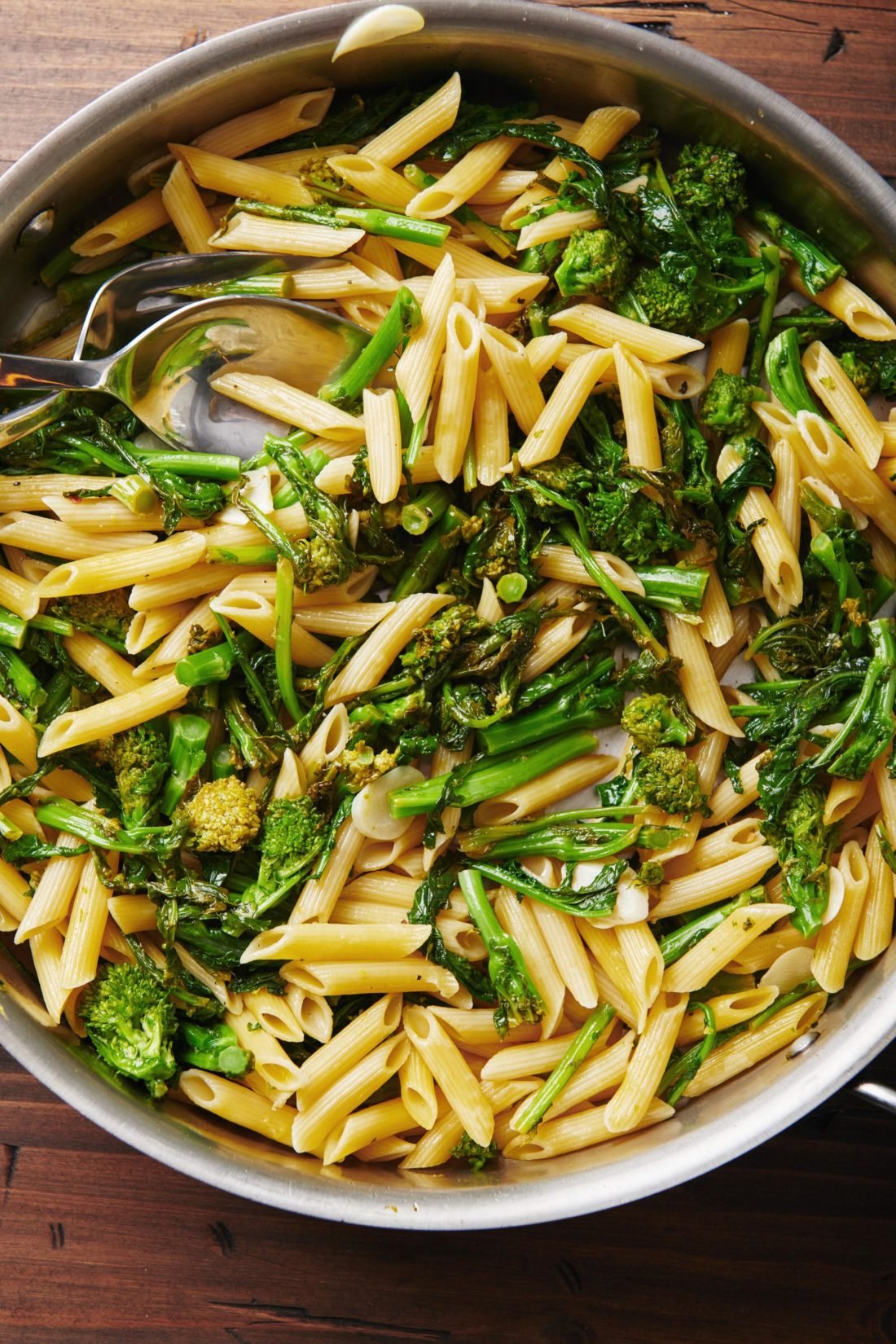 Silverware in a pan of Pasta with Broccoli Rabe.