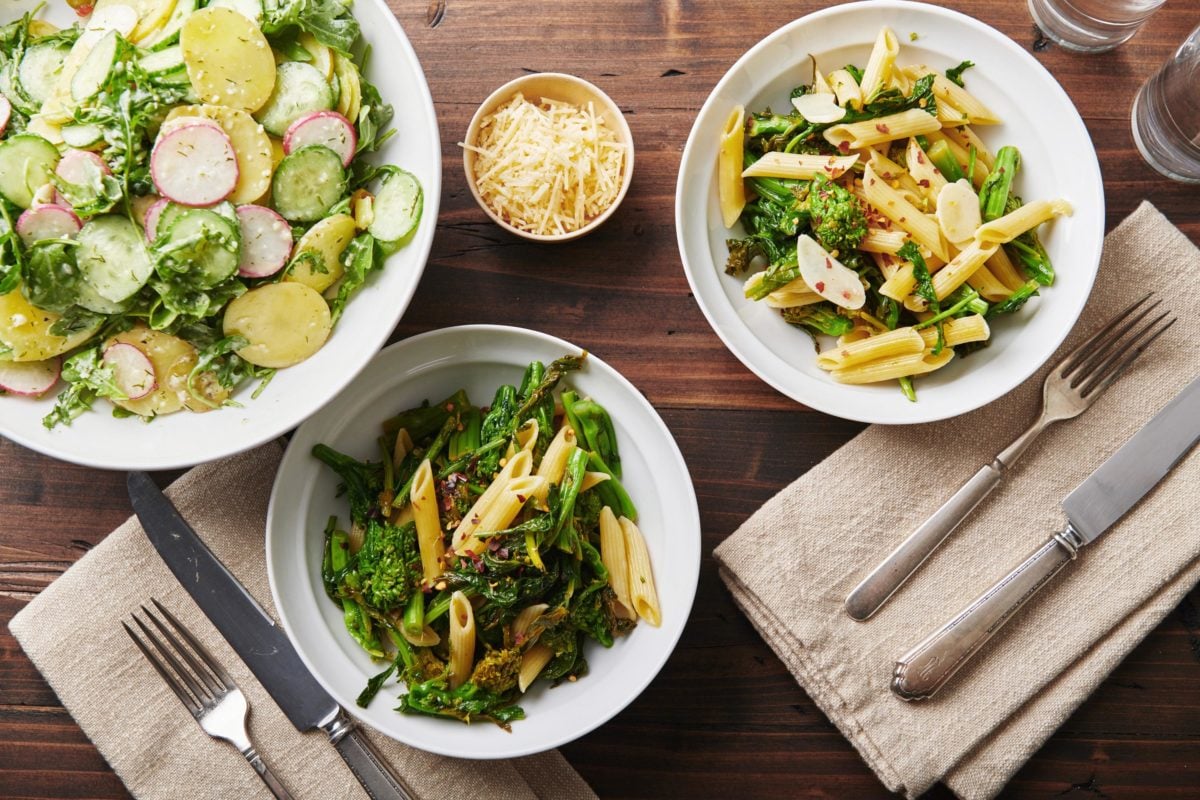 Bowls of Pasta with Broccoli Rabe on a wooden table.