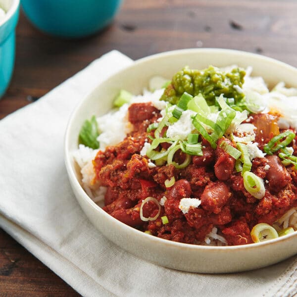 Ground beef chili on plate over rice.